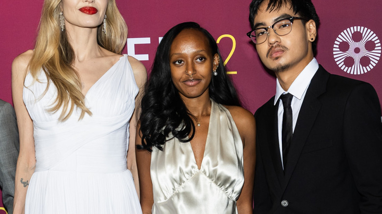 Zahara Jolie-Pitt poses on the red carpet with Angelina Jolie and Maddox Jolie-Pitt