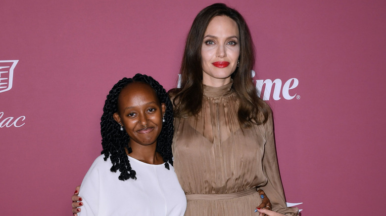 Zahara Jolie-Pitt poses next to Angelina Jolie with shoulder-length hair