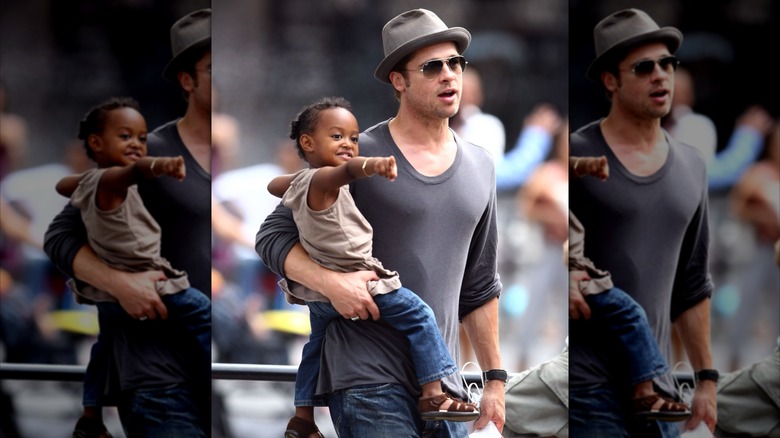 Brad Pitt holding young Zahara Jolie