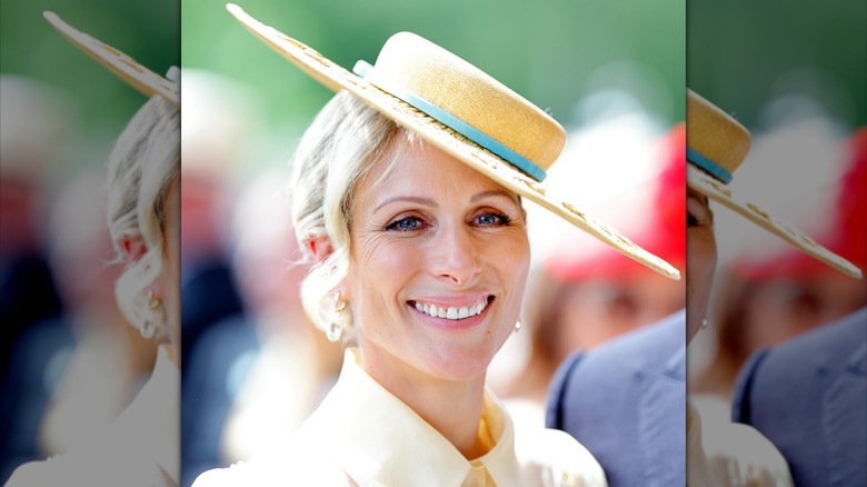 Zara Tindall smiling while wearing a boater hat