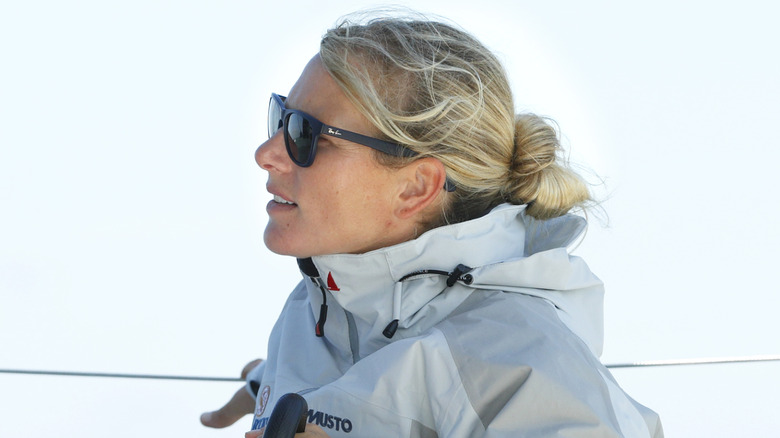 Side profile of Zara Tindall in sunglasses and rain coat