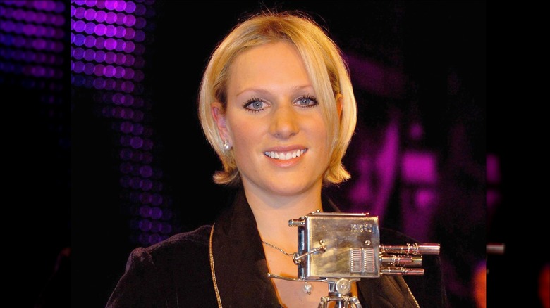 Short-haired Zara Tindall posing with a trophy
