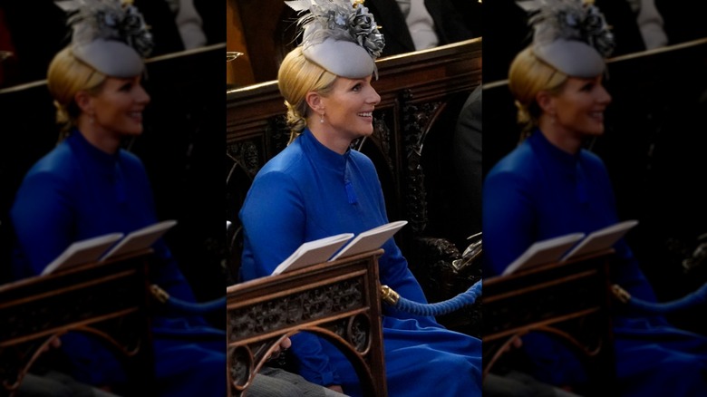A side profile of Zara Tindall's hair in blue dress and silver fascinator