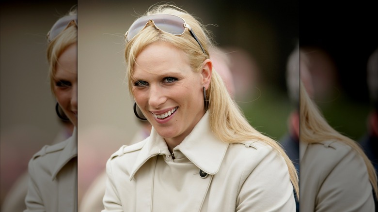 Zara Tindall posing with sunglasses resting atop her head
