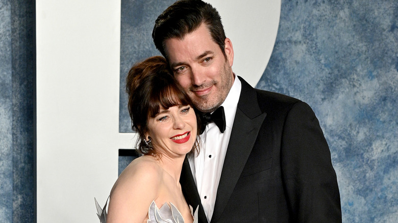 Jonathan Scott and Zooey Deschanel smile and hug