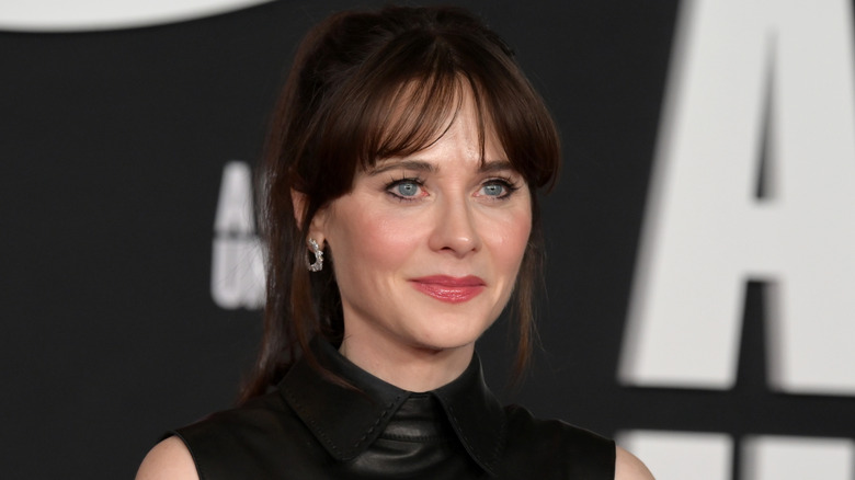 Zooey Deschanel in a black collared leather outfit