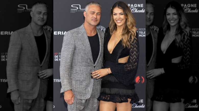 Taylor Kinney with his arm around a smiling Ashley Cruger