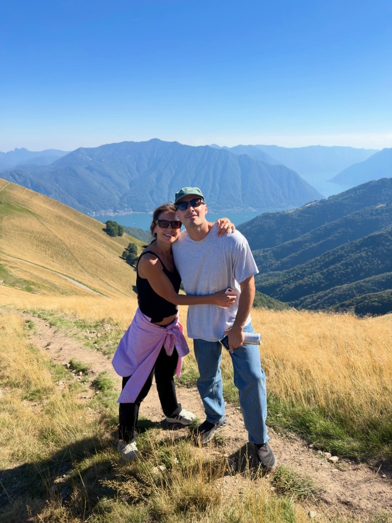 Katie Holmes and Jason Bard Yarmosky hugging on a trail in Italy