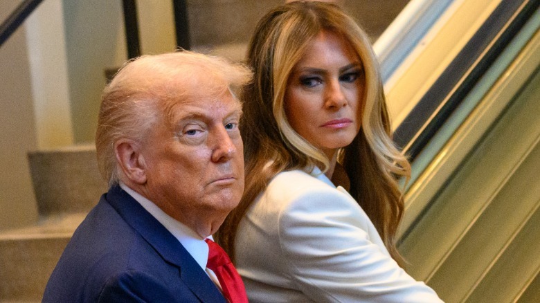 U.S. President Donald Trump and first lady Melania Trump step on an escalator as they arrive for the 80th session of the UN's General Assembly (UNGA) on September 23