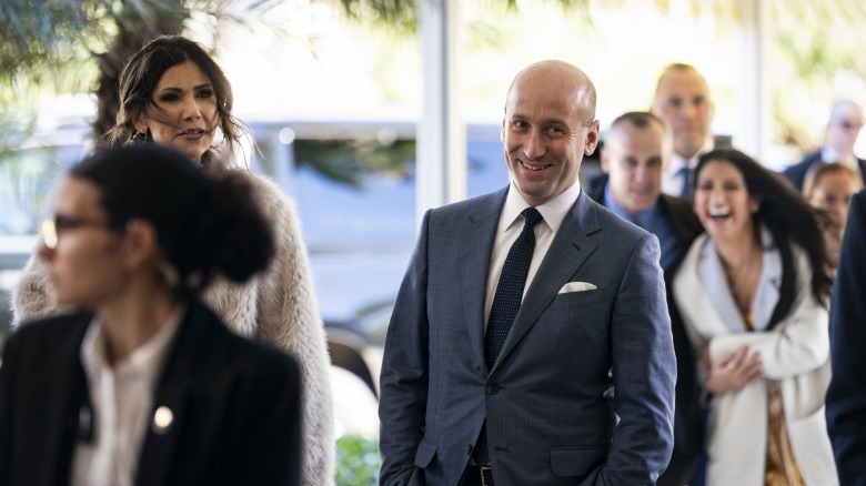 Kristi Noem and Stephen Miller enter Mar-a-Lago. Behind them