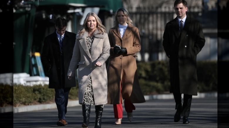 Karoline Leavitt smiling and walking