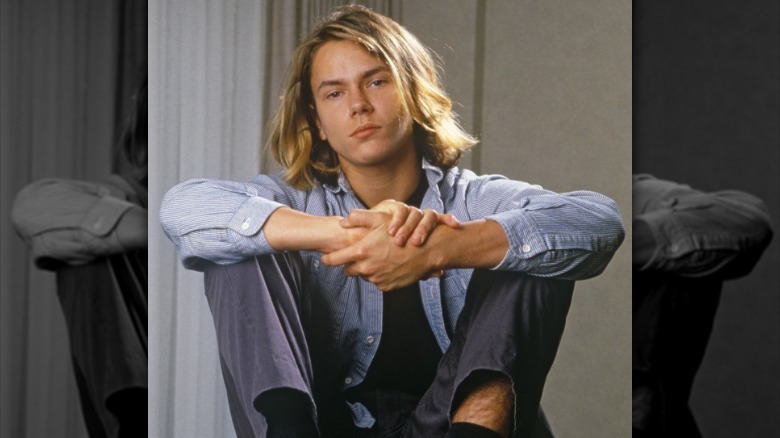 River Phoenix sitting