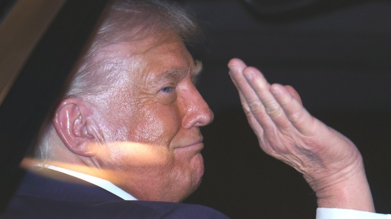 Donald Trump with shiny greasy orange face waving goodbye in Tokyo