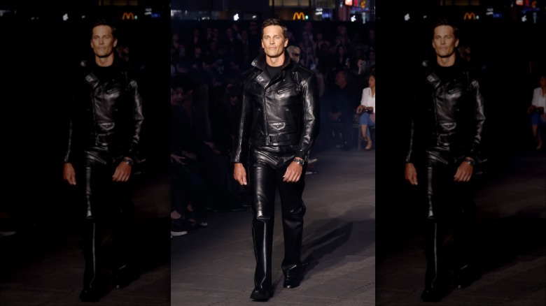 Tom Brady walking the Gucci Restort '27 runway in an all-leather outfit in New York City's Time Square