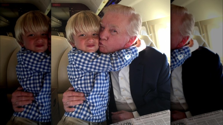 Donald Trump holds Tristan Trump inside a plane