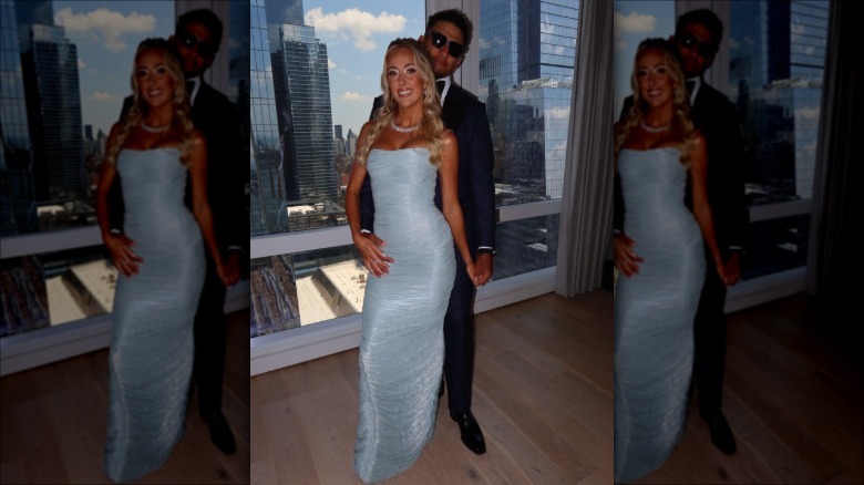 Brittany Mahomes wearing a baby blue dress next to Patrick Mahomes