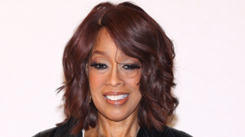 Gayle King smiles with her hair layered and styled with a side part.
