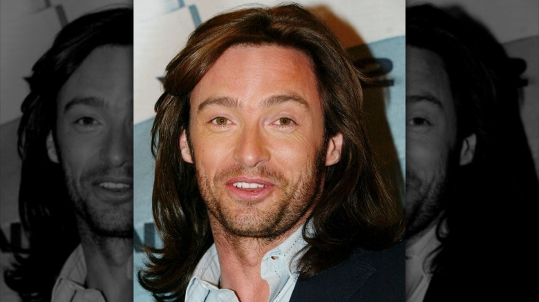 Hugh Jackman with long hair smiling