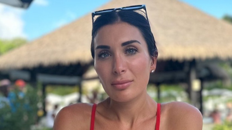 Laura Loomer posing with sunglasses on head