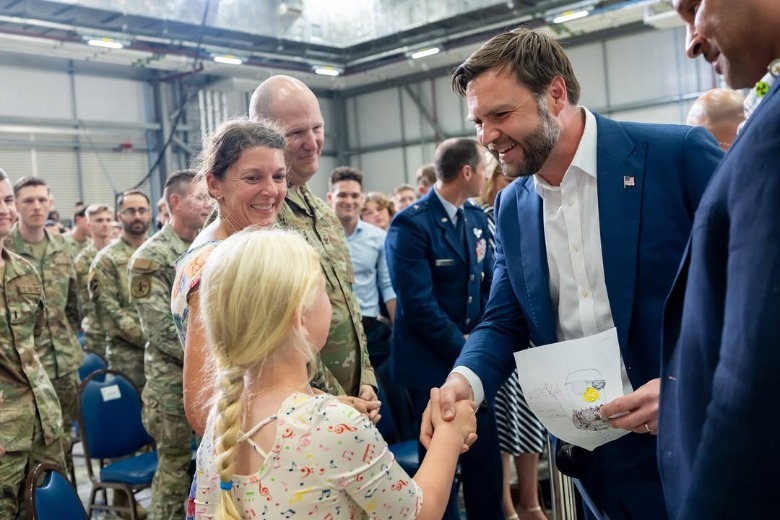 JD Vance shakes hands with a little girl