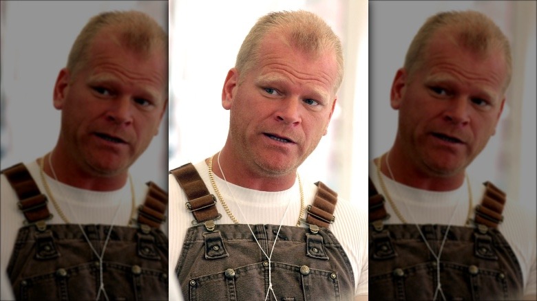 Mike Holmes wearing overalls