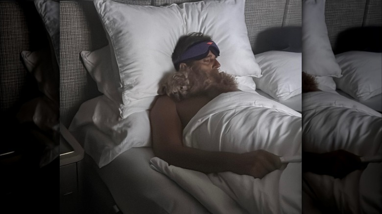 Bill Rancic sleeping with a small dog on his chest