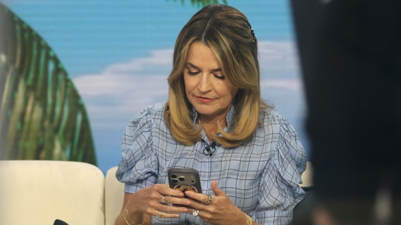 Savannah Guthrie looking at her phone on the set of