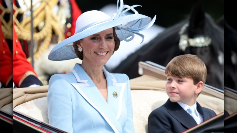 Kate Middleton smiling while Prince Louis looks at her