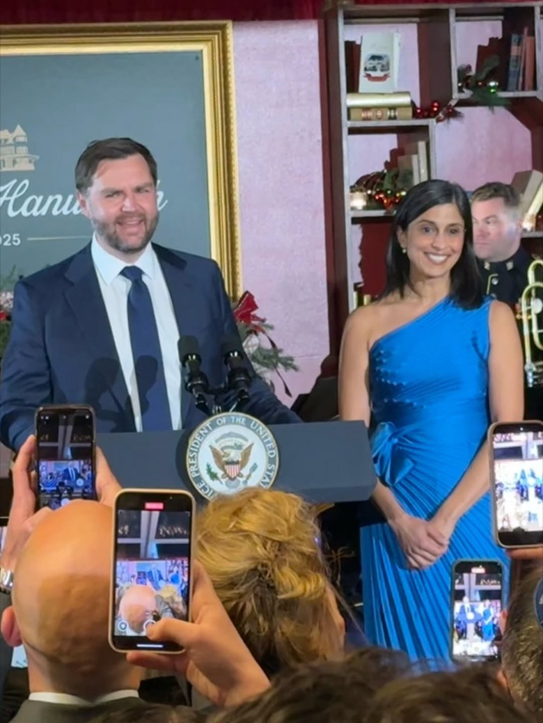 JD Vance and Usha Vance smiling while standing at podium