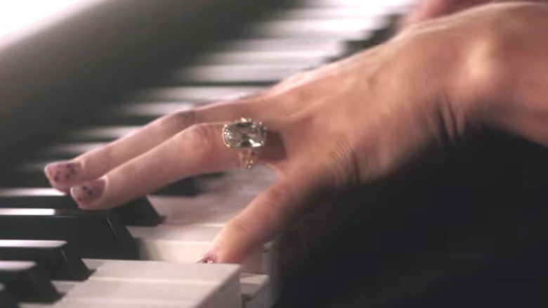 close-up of Taylor Swift's wedding and engagment ring as she plays the piano