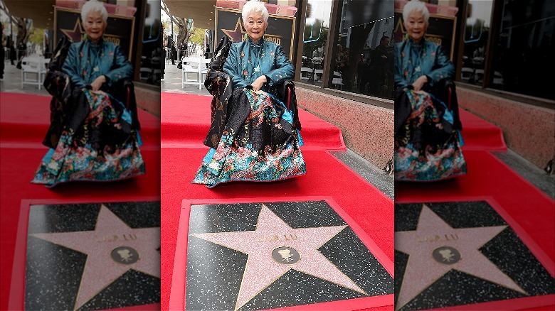Lisa Lu sitting by her star on the Hollywood Walk of Fame