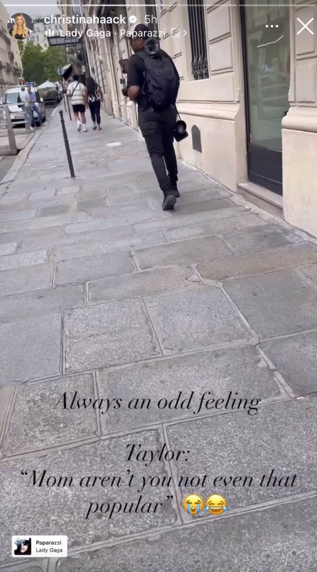 Photographer walking away down a cement path