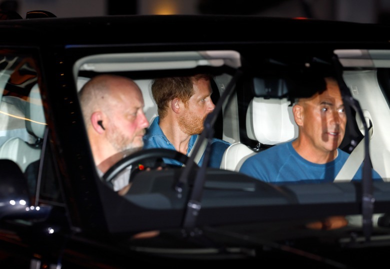 Prince Harry riding in back of car with seatbelt on