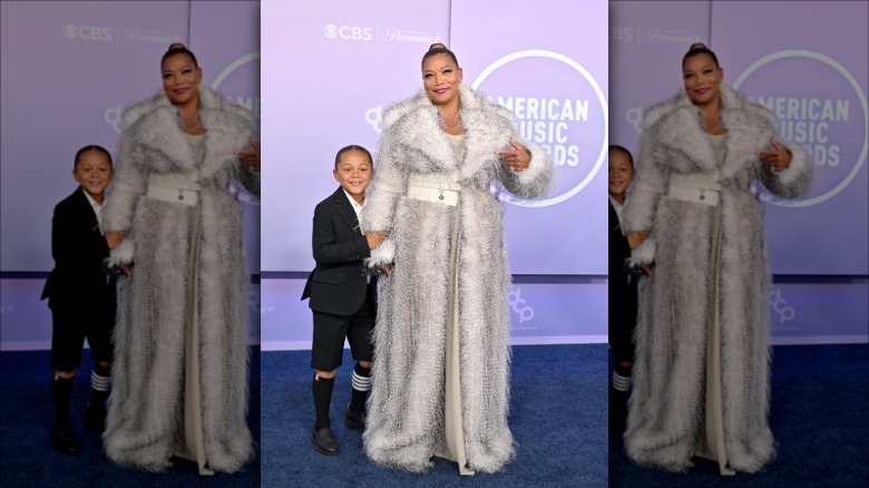 Queen Latifah holding her son Rebel's hand on the American Music Awards red carpet