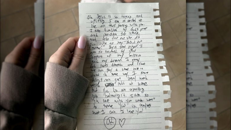 Erika Kirk holding a note