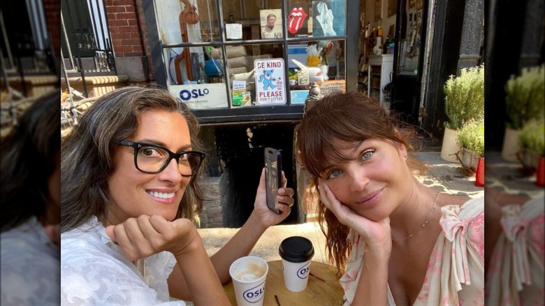Yasmeen Ghauri smiling next to Helena Christensen