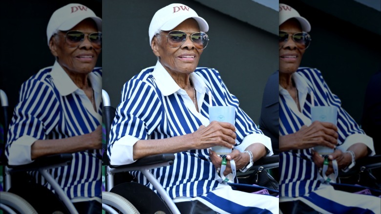 Dionne Warwick sitting and holding a cup